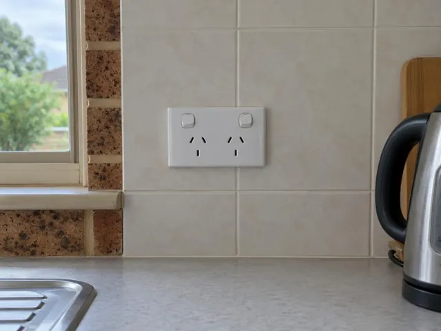 Double power point on tiled kitchen splashback beside a window and benchtop in Booragul