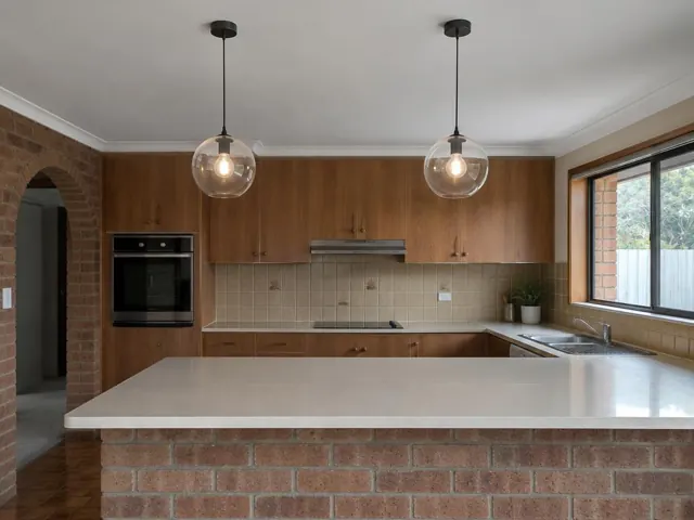 Kitchen with two glass pendant lights above a brick island bench in Glendale